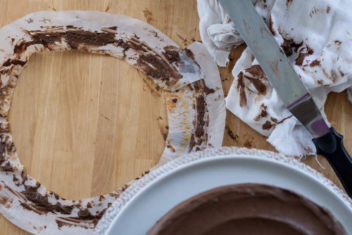 Learn how to keep your serving plate clean while frosting a cake. This simple trick uses items you already have on hand in your kitchen. From Flour Arrangements.