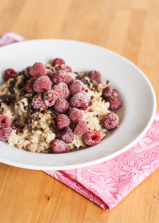 A hearty breakfast of oatmeal with raspberries and cocoa nibs will get your day off to the right start.