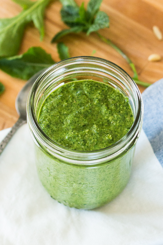 A departure from traditional basil pesto, this arugula-basil pesto blends spicy arugula, sweet basil, and fresh mint to create a unique summer recipe. Pine nuts, slivered almonds, garlic, and capers round out the flavors in this easy, versatile sauce. 