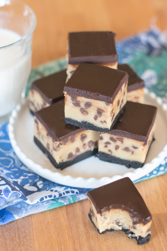 Rich chocolate chip cookie dough brownie bites combine three impossibly delicious layers of goodness. This decadent recipe features a thin, dense chocolate brownie topped with chocolate chip cookie dough smothered with chocolate ganache. 