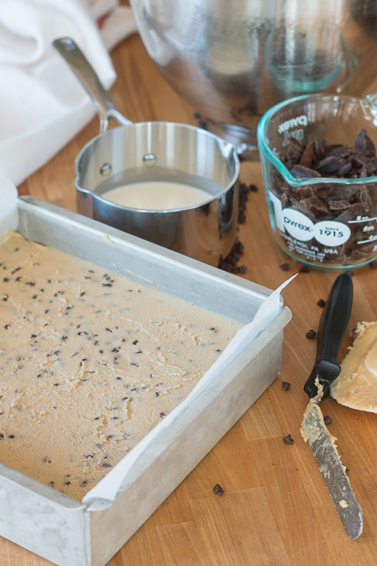 Rich chocolate chip cookie dough brownie bites combine three impossibly delicious layers of goodness. This decadent recipe features a thin, dense chocolate brownie topped with chocolate chip cookie dough smothered with chocolate ganache. 