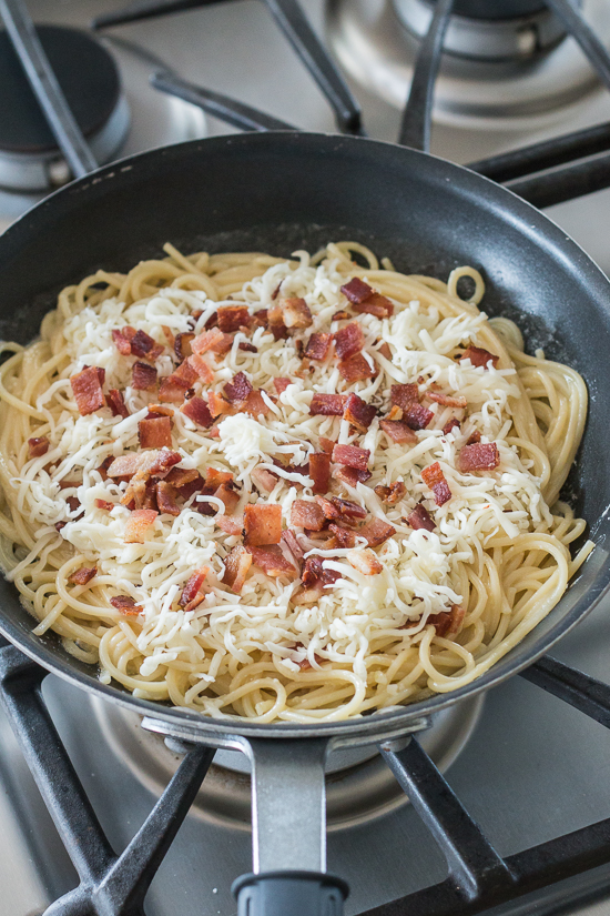 With bacon and cheese tucked in the center, this savory noodle cake tastes delicious topped with fresh summer tomatoes. This simple, flavorful recipe is easy to prepare. It's a great way to use up leftover spaghetti, too!