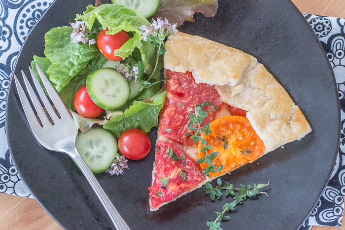 Simple yet stunning, this tomato galette turns juicy, ripe tomatoes into a satisfying, delicious meal. Gouda and smoked mozzarella provide a rich, slightly smoky backdrop to the bright tomato flavor.