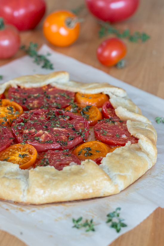 Simple yet stunning, this tomato galette turns juicy, ripe tomatoes into a satisfying, delicious meal. Gouda and smoked mozzarella provide a rich, slightly smoky backdrop to the bright tomato flavor.