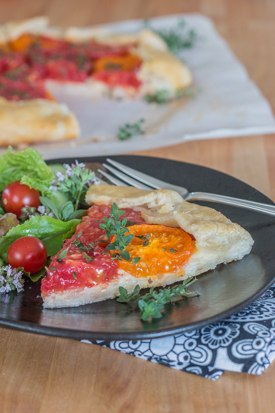 Simple yet stunning, this tomato galette turns juicy, ripe tomatoes into a satisfying, delicious meal. Gouda and smoked mozzarella provide a rich, slightly smoky backdrop to the bright tomato flavor.