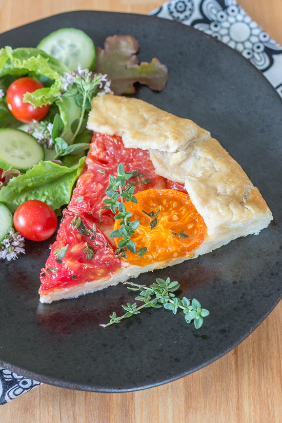 Simple yet stunning, this tomato galette turns juicy, ripe tomatoes into a satisfying, delicious meal. Gouda and smoked mozzarella provide a rich, slightly smoky backdrop to the bright tomato flavor.