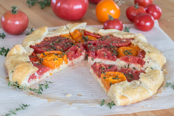 Simple yet stunning, this tomato galette turns juicy, ripe tomatoes into a satisfying, delicious meal. Gouda and smoked mozzarella provide a rich, slightly smoky backdrop to the bright tomato flavor.