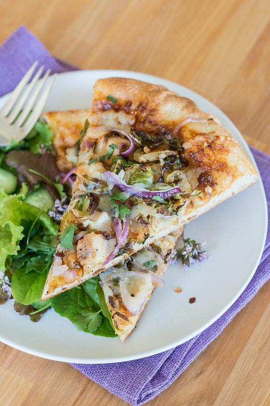 Sweet, tangy barbecue sauce provides a flavorful, fun twist to homemade pizza. Topped with cooked chicken, roasted Brussels sprouts, red onion and Gruyere cheese, this simple barbecue pizza tastes totally gourmet!