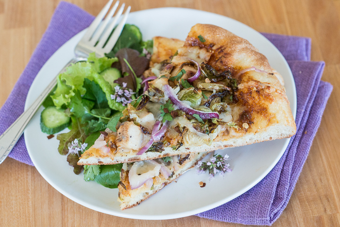 Sweet, tangy barbecue sauce provides a flavorful, fun twist to homemade pizza. Topped with cooked chicken, roasted Brussels sprouts, red onion and Gruyere cheese, this simple barbecue pizza tastes totally gourmet!