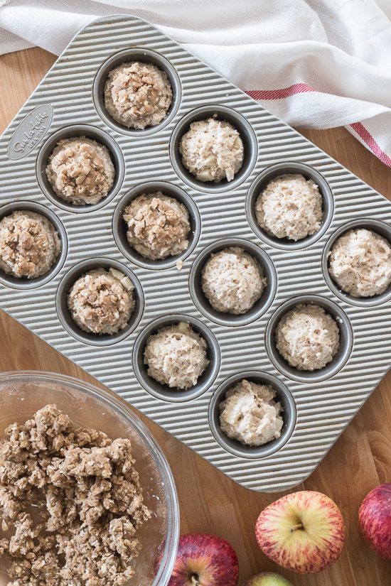 Packed with diced apple, sweetened with maple syrup, and spiced with cinnamon, these maple-oat apple muffins get extra sweetness and texture from a lightly spiced streusel topping. Oven warm and slathered with maple-cinnamon mascarpone, they're a perfect fall treat.