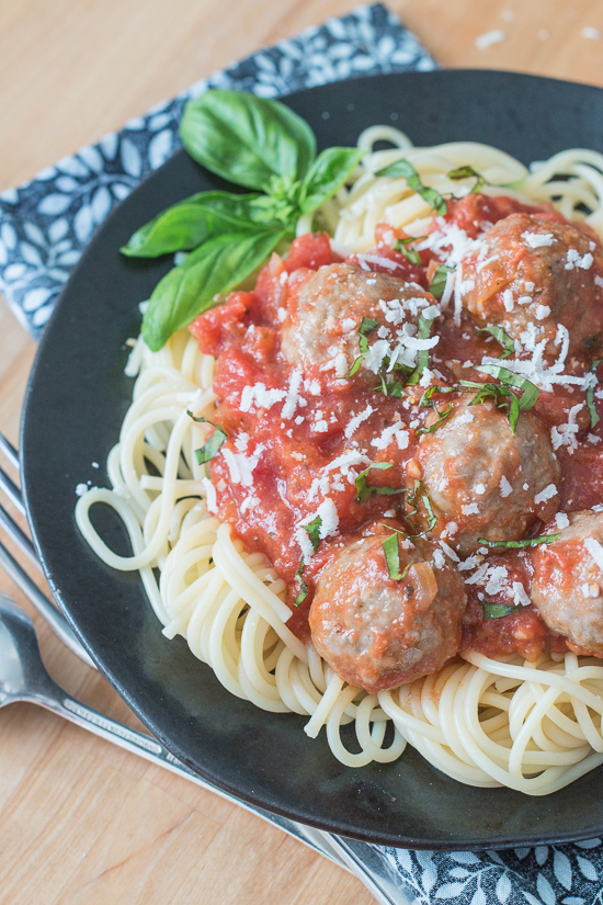 Ladled over spaghetti, these classic meatballs with simple tomato sauce epitomize hearty comfort food. Serve a crowd with this generous recipe or hoard the leftovers for easy meal planning.