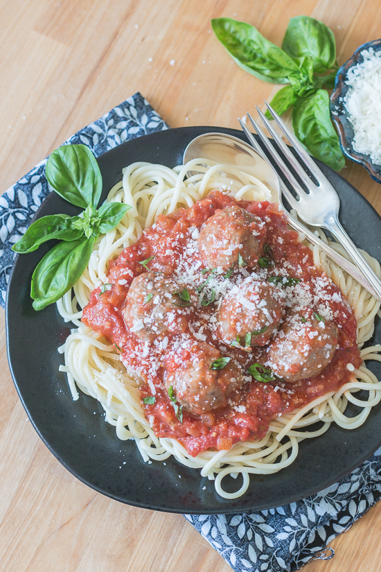 Ladled over spaghetti, these classic meatballs with simple tomato sauce epitomize hearty comfort food. Serve a crowd with this generous recipe or hoard the leftovers for easy meal planning.