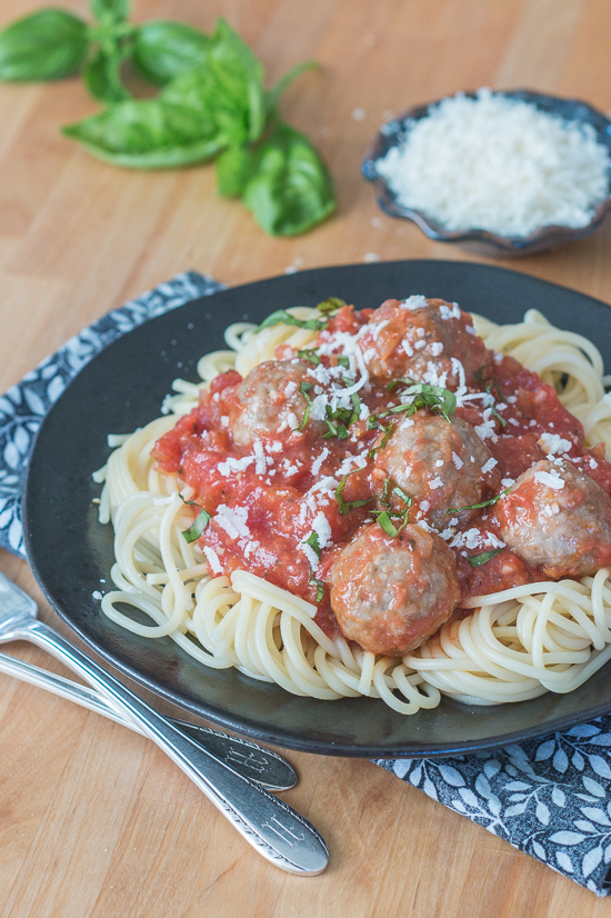 Ladled over spaghetti, these classic meatballs with simple tomato sauce epitomize hearty comfort food. Serve a crowd with this generous recipe or hoard the leftovers for easy meal planning.