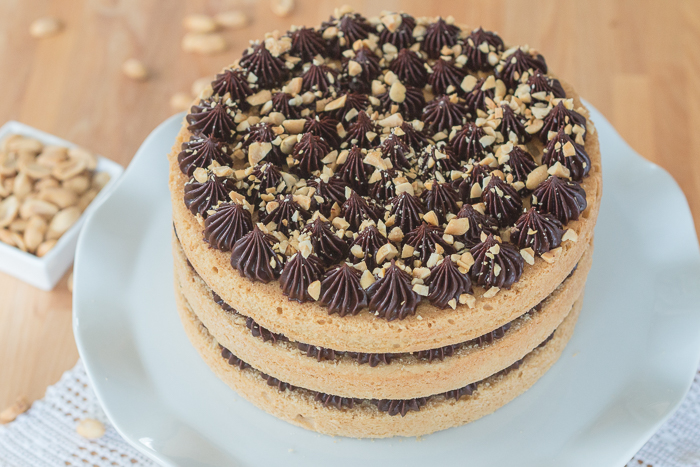 Sweet, nutty cake layers interspersed with a decadent ganache come together in this peanut butter cake with chocolate ganache. Indulgent and flavorful, this cake is a peanut butter lover's dream.