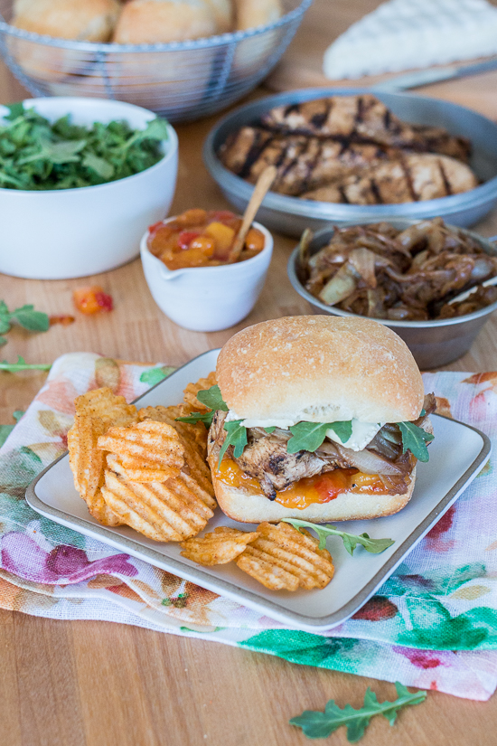 These Grilled Chicken and Brie Sandwiches with Mango Chutney and Balsamic Onions make a perfect meal or party dish! Ciabatta, with its chewy open texture, offers up plenty of nooks and crannies to capture the rich, creamy Brie, tangy mango chutney, and tender balsamic onions.