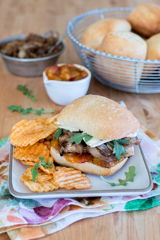 These Grilled Chicken and Brie Sandwiches with Mango Chutney and Balsamic Onions make a perfect meal or party dish! Ciabatta, with its chewy open texture, offers up plenty of nooks and crannies to capture the rich, creamy Brie, tangy mango chutney, and tender balsamic onions.