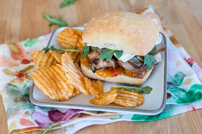 These Grilled Chicken and Brie Sandwiches with Mango Chutney and Balsamic Onions make a perfect meal or party dish! Ciabatta, with its chewy open texture, offers up plenty of nooks and crannies to capture the rich, creamy Brie, tangy mango chutney, and tender balsamic onions.