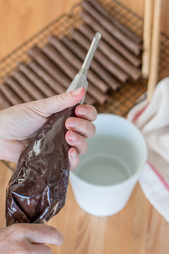 These Chocolate Tuile Cigars with Whisky Ganache feature wafer-thin chocolate cookies loaded with boozy chocolate. This truly decadent treat provides a sweet alternative to the idea of celebratory cigars!