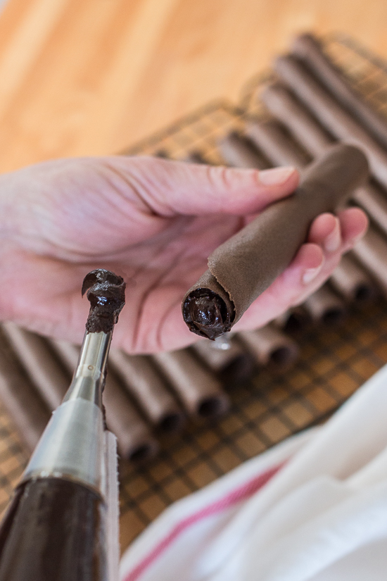 These Chocolate Tuile Cigars with Whisky Ganache feature wafer-thin chocolate cookies loaded with boozy chocolate. This truly decadent treat provides a sweet alternative to the idea of celebratory cigars!