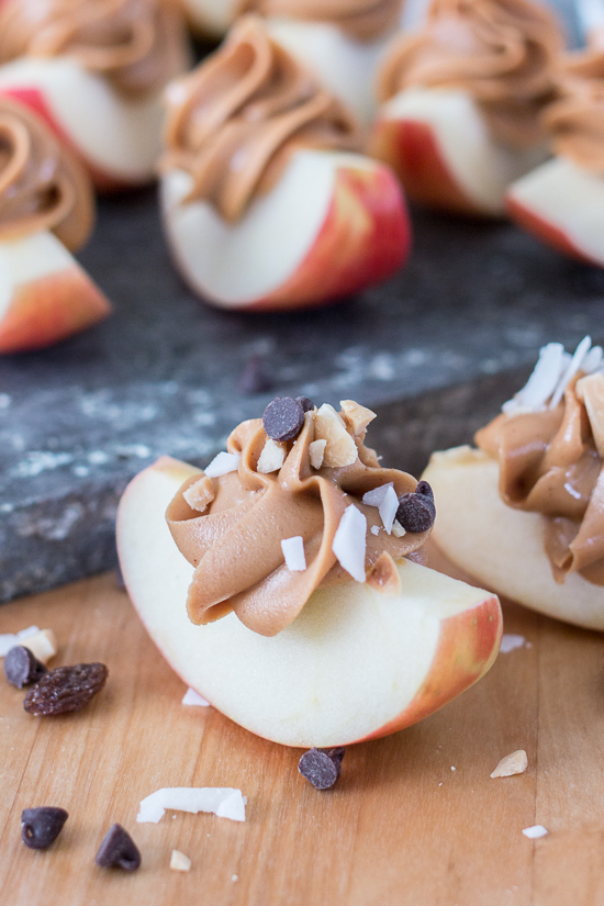 Dress up a simple, wholesome snack of Peanut Butter Apple Slices by piping creamy peanut butter in small spirals atop crisp, tart apples. Sprinkling toppings like mini chocolate chips, toasted coconut, or raisins over these apple-tizers adds to the fun of this easy, healthy snack. 