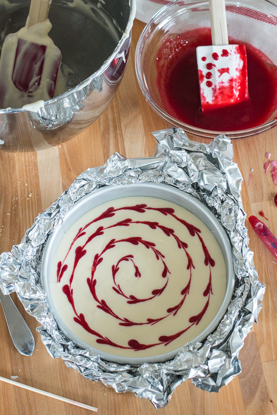 Smooth and indulgent, this Vanilla Raspberry Cheesecake hides a surprise layer of tart raspberry filling in the center. Decorative heart embellishments add flair to this petite, delicious cheesecake. 