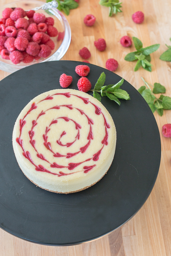 Smooth and indulgent, this Vanilla Raspberry Cheesecake hides a surprise layer of tart raspberry filling in the center. Decorative heart embellishments add flair to this petite, delicious cheesecake. 