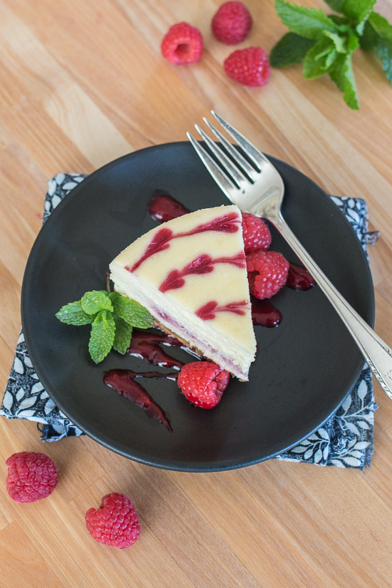 Smooth and indulgent, this Vanilla Raspberry Cheesecake hides a surprise layer of tart raspberry filling in the center. Decorative heart embellishments add flair to this petite, delicious cheesecake. 