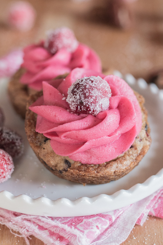 With their deep pink cranberry buttercream and glittery sugared cranberries, these pretty Muffin Tin Cranberry-Pecan Blondies make a great, easy-to-serve dessert for festive occasions.