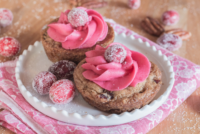 With their deep pink cranberry buttercream and glittery cranberries, these pretty Muffin Tin Cranberry-Pecan Blondies make a great, easy-to-serve dessert for festive occasions.