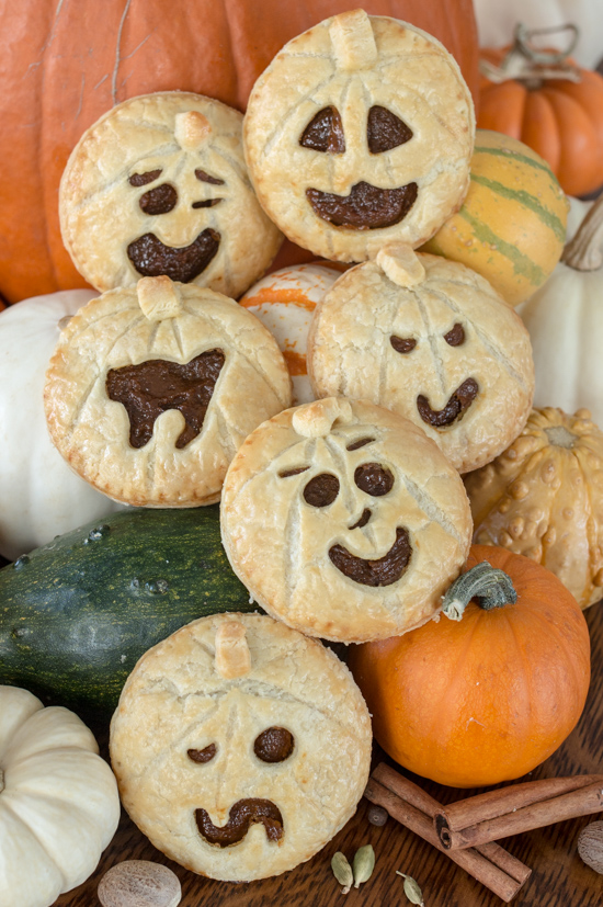 Perfect for Halloween, these adorable Jack-O'-Lantern Pumpkin Hand Pies feature a velvety-smooth pumpkin filling tucked between layers of rich, flaky pastry. 