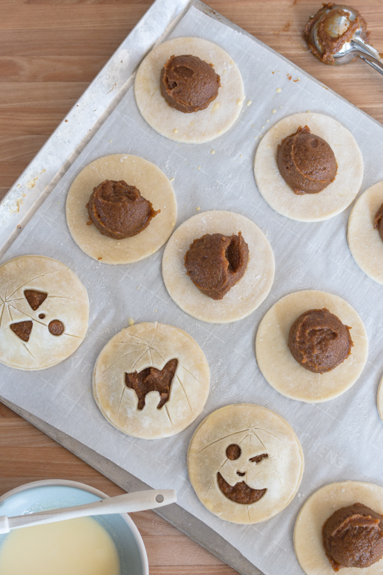 Perfect for Halloween, these adorable Jack-O'-Lantern Pumpkin Hand Pies feature a velvety-smooth pumpkin filling tucked between layers of rich, flaky pastry. 