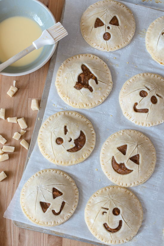 Perfect for Halloween, these adorable Jack-O'-Lantern Pumpkin Hand Pies feature a velvety-smooth pumpkin filling tucked between layers of rich, flaky pastry. 