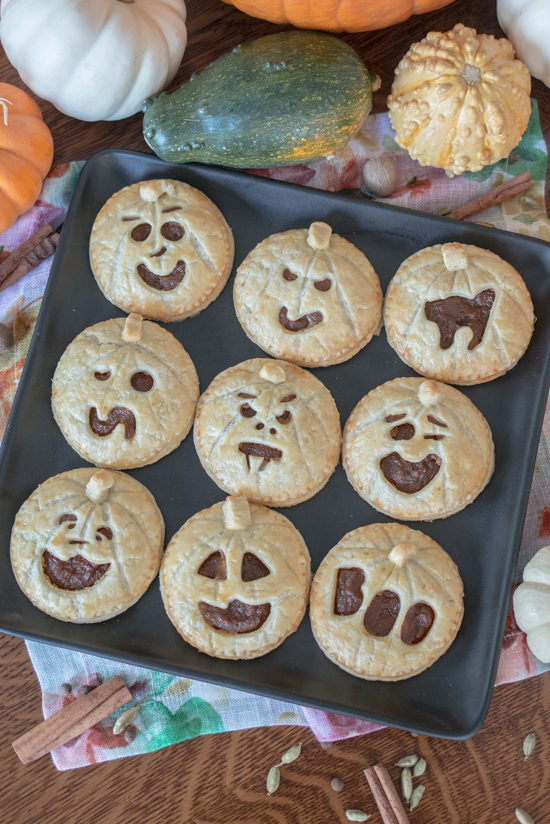 Perfect for Halloween, these adorable Jack-O'-Lantern Pumpkin Hand Pies feature a velvety-smooth pumpkin filling tucked between layers of rich, flaky pastry. 