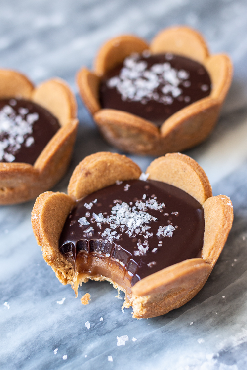 Spicy gingerbread cookie crusts provide a bold, flavorful backdrop for sweet caramel and rich, smooth ganache in these Mini Salted Caramel-Chocolate Tarts. 