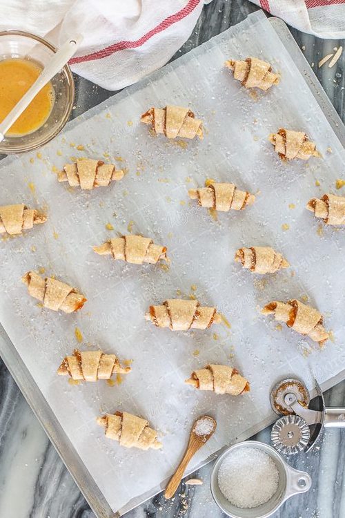 Tender, flaky cream cheese pastry provides the perfect vehicle for apricot jam and sweet almond filling in these Apricot-Almond Rugelach.