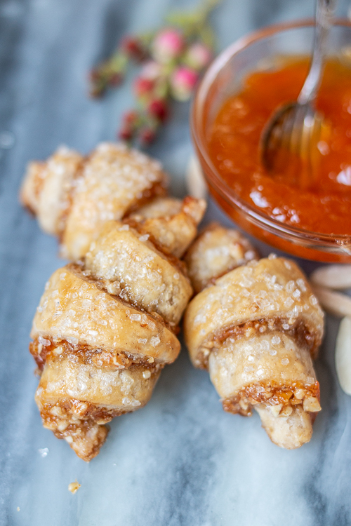 Tender, flaky cream cheese pastry provides the perfect vehicle for apricot jam and sweet almond filling in these Apricot-Almond Rugelach.