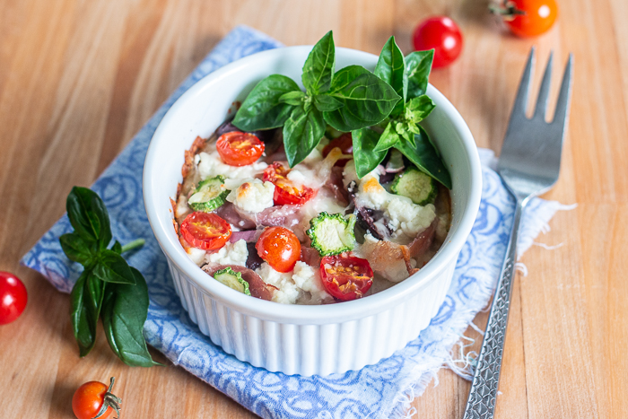 Comforting and delicious, these Easy Baked Polenta Cups feature a thick layer of polenta mounded with rich cheese, chopped vegetables and diced meats. With endless topping choices, this customizable recipe makes a perfect dinner bar meal. 