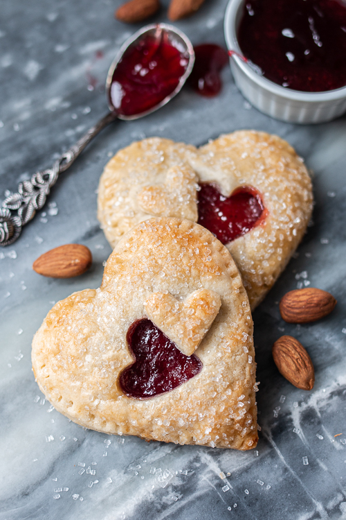 Jammy Almond Hand Pies feature nutty almond filling and fruity jam tucked inside flaky pastry dough. Shaped like hearts, they're perfect for Valentine's Day!